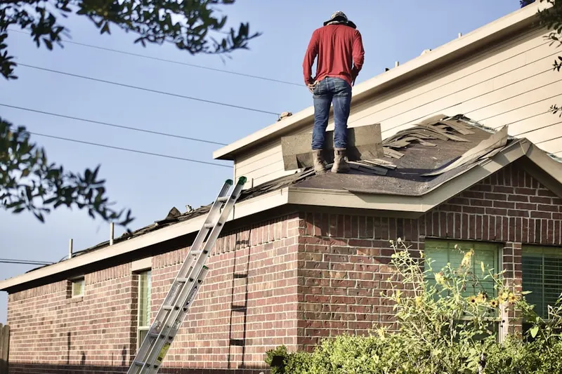 Professional roofer working on a residential roof in Perry Heights